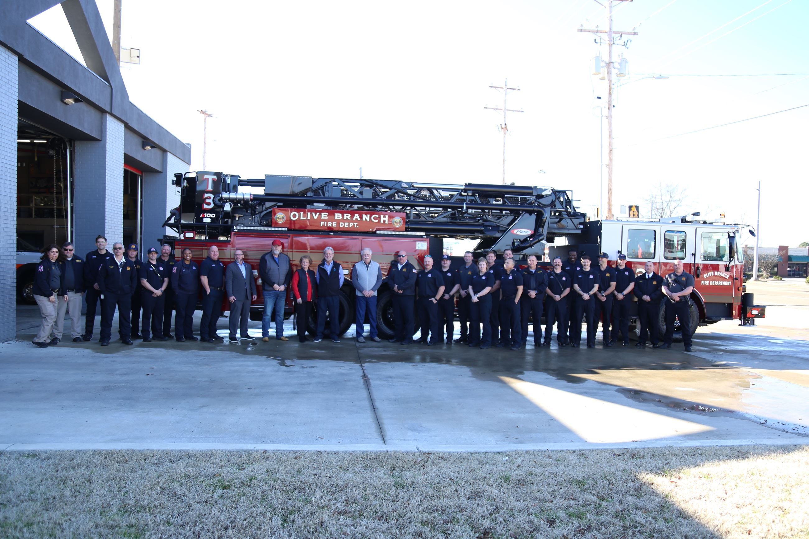 City Staff and Station members of the OBFD stand in front of the new engine